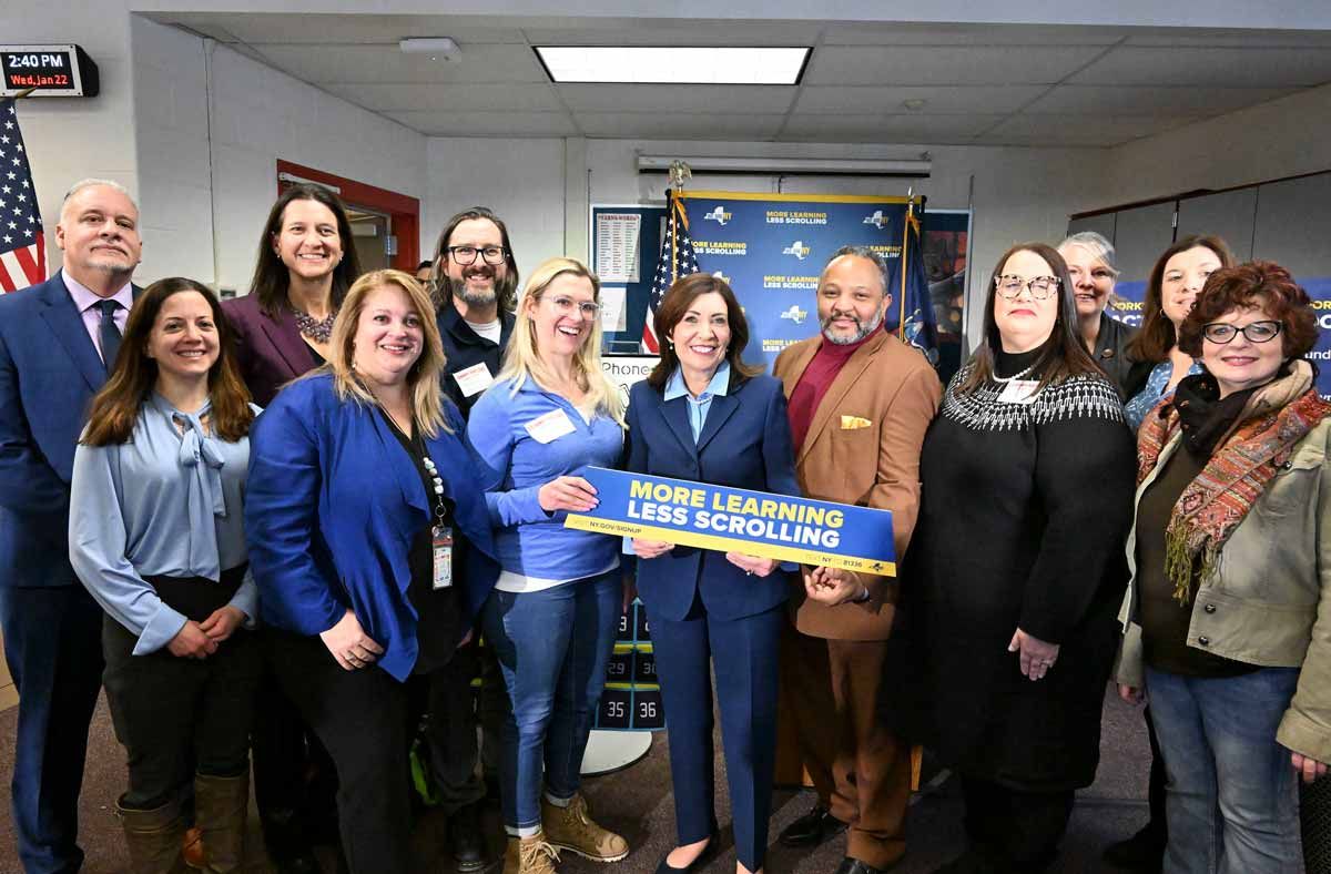 Group of people standing with Gov. Hochul