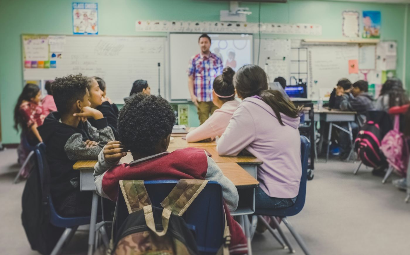 Teacher talking to students in a classroom